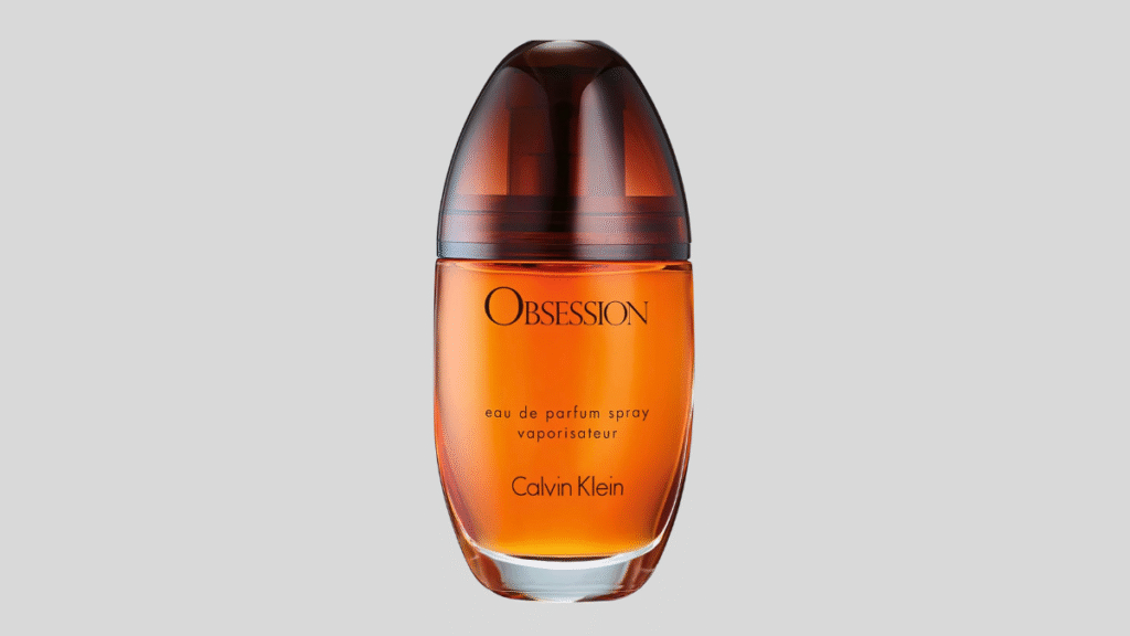 Frasco de perfume âmbar em destaque sobre fundo cinza